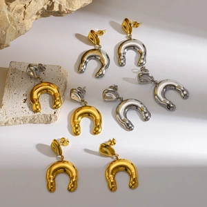 Close-up macro view showing various colors of stylish horseshoe-shaped steel earrings