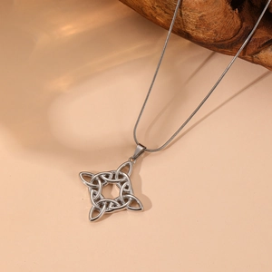 Detail view of a silver Celtic knot pendant with opal stone on a sleek snake chain