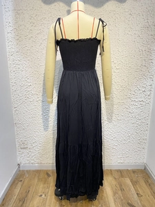Detail of black maxi dress featuring adjustable tie back and elastic high waist design