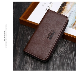 Detailed macro view of dark brown litchi grain leather and metal zipper on men's long wallet