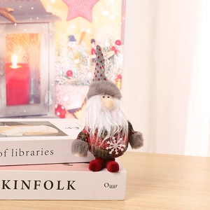 Close-up of Christmas gnome plush with snowflake detail and festive red boots