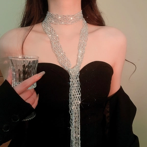 Detailed view of luxury crystal beaded tassel scarf necklace on a model's neck