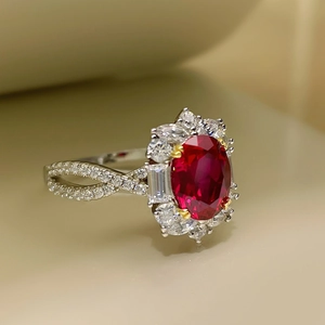 Elegant red oval gemstone ring with pavé diamonds on a double twisted silver band