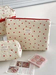 Quilted makeup bag set with red hearts pattern in three different storage sizes