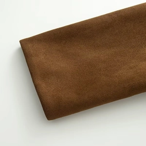 Close-up of premium brown faux suede fabric showing soft texture for motor jacket