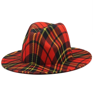 Detail of red and black tartan plaid fedora hat with stiff wide brim for winter fashion