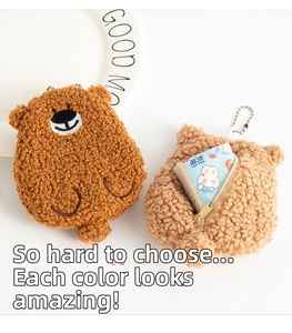 Close-up of curly plush bear coin pouches in brown and beige with metal chain