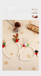 Detail of Christmas reindeer antler headbands with colorful plush balls and faux fur