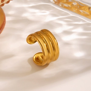 Minimalist gold geometric triple-layer open ring shown against a luxury water shadow background