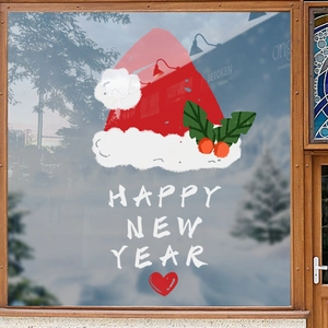 Christmas window stickers with Happy New Year text and Santa hat on glass background