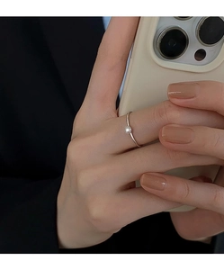 Detail of s925 silver pearl ring worn on hand, minimalist style for an elegant look