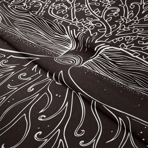 Close-up of bohemian tree of life tapestry showing black polyester fabric and intricate white patterns