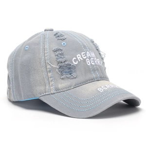 Detailed macro of distressed grey cotton baseball cap with white 3D embroidery textures