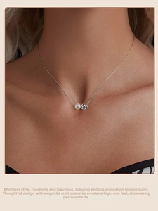 Gros plan d'un collier en argent S925 avec perle blanche et moissanite sur le cou
