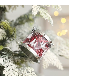 Close-up of red and silver Christmas drum ornament with white pine tree print on a tree