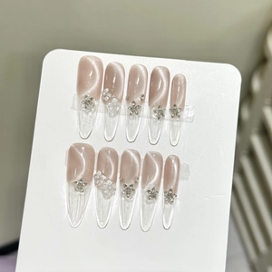French champagne pink cat-eye press-on nails with silver stars and 3D floral accents