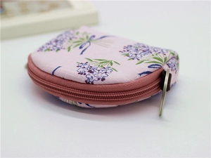 Detail of semi-circular floral fabric coin purse with pink zipper and silver keyring