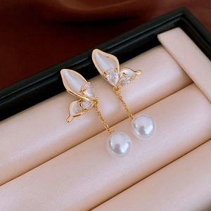 Elegant gold butterfly earrings with white pearls and zircons in a velvet gift box