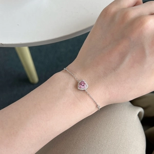 Close-up of S925 sterling silver bracelet with pink heart zirconia and pavé stones