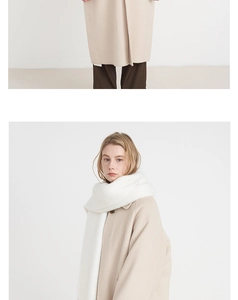 Detail showing high-quality white cashmere feel scarf paired with beige wool coat
