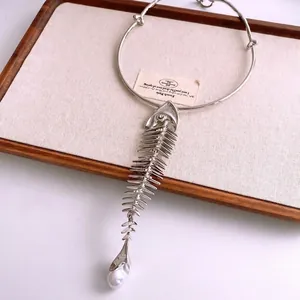 French luxury fishbone necklace with crystal accents and natural pearl pendant