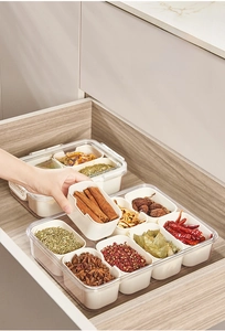 Detail of multi-grid kitchen spice organizer with seal lids showing herb storage