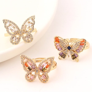 Close-up of butterfly rings featuring colorful cubic zirconia stones and gold plating