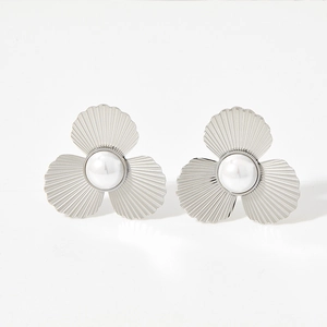 Silver flower stud earrings with central pearls shown on a clean white background