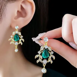 Vintage gold leaf drop necklace with emerald stone and sparkling diamond accents