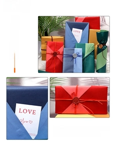 Detail of DIY gift wrapping kit with matte white paper, colored ribbons, and wax seals
