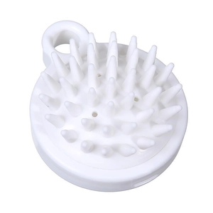 Minimalist white silicone scalp massage brush with soft bristles and hanging hook design