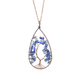 Detail of copper wire wrapped Tree of Life pendant with teardrop blue natural stones