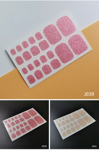 Detail view of J039 pink and J041 beige glitter toenail stickers showing sparkle texture