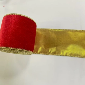 Detailed view of red velvet Christmas ribbon with metallic gold wired edges for tree decor