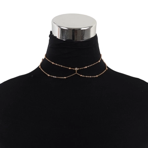Detail of rose gold double-layered choker necklace with crystal pendant on neck model