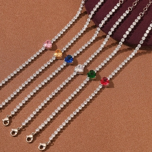 Luxurious 18K gold heart zircon bracelet in six vibrant colors on a textured background