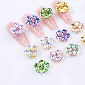 Detailed view of 3D crystal five-petal flower nail charms in various sparkling colors
