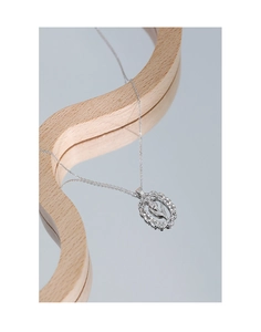 Detailed view of S925 silver necklace with oval tulip flower hollow pendant on wood