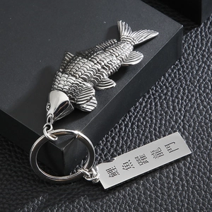 Detail of silver stainless steel koi carp keychain with engraved lucky rectangular plate