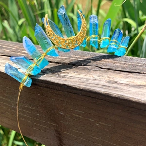 Close-up of blue crystal moon crown crown with handmade gold wire wrapping and crescent detail