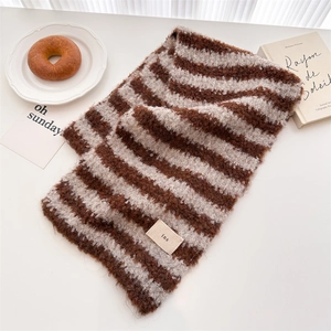 Detail of soft brown and white striped wool scarf with an ins label on a table