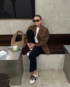 Street style view of oversized brown suede blazer with white knitwear and black jeans