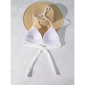 Detail view of white halter bikini top with washing label showing fabric composition