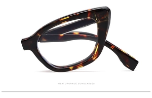 Folded tortoiseshell cat-eye sunglasses with translucent frame on a white background