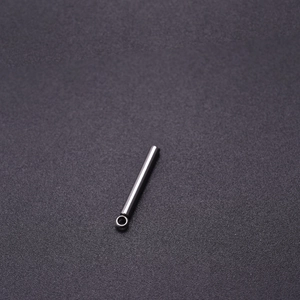 Detailed view of a slender cylindrical 304 stainless steel pendant with connector ring