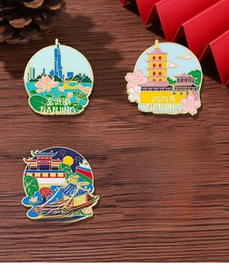 Detail view of four metal enamel pins featuring Nanjing city landmarks on wood background