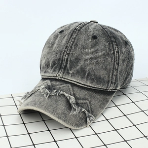 Detailed view of the frayed brim and washed denim texture on a vintage baseball cap