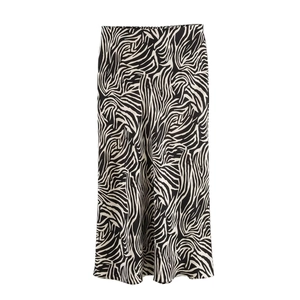 Detail of satin midi skirt showcasing bold black and white zebra print and smooth texture
