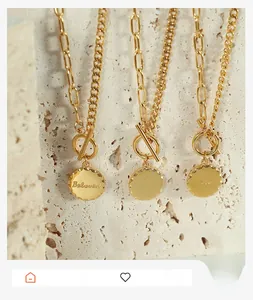 Detail of gold OT toggle necklace with a round coin pendant engraved with Beloved text