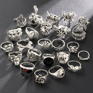 Macro shot of 24pcs gothic punk rings featuring skull and octopus motifs in antique silver